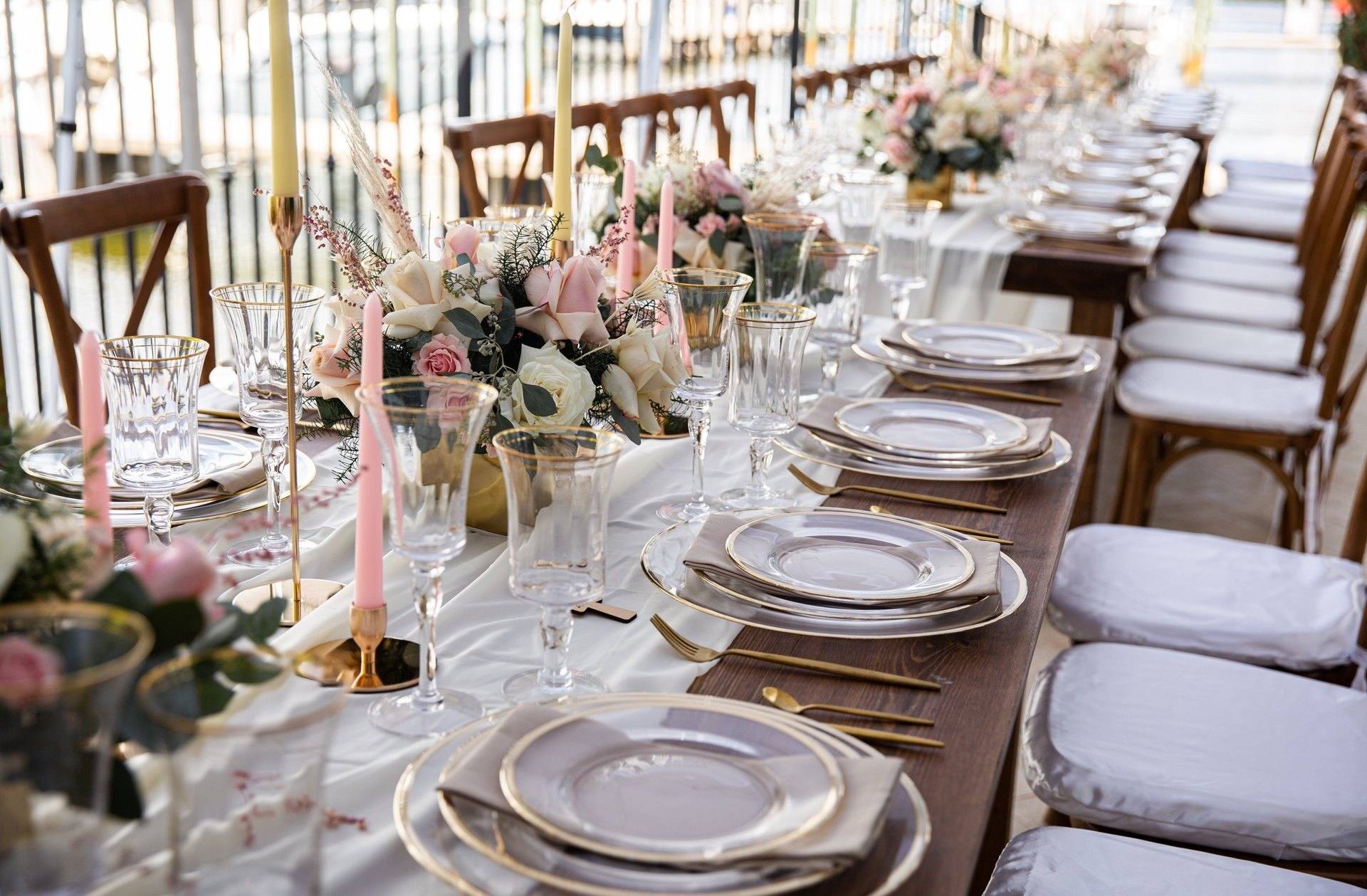 Long white reception table with flowers