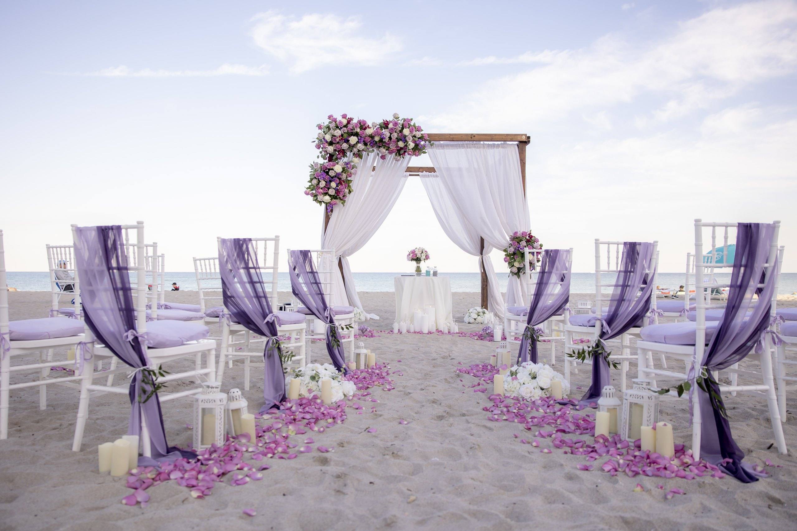 Beach aisle lined with purple flowers