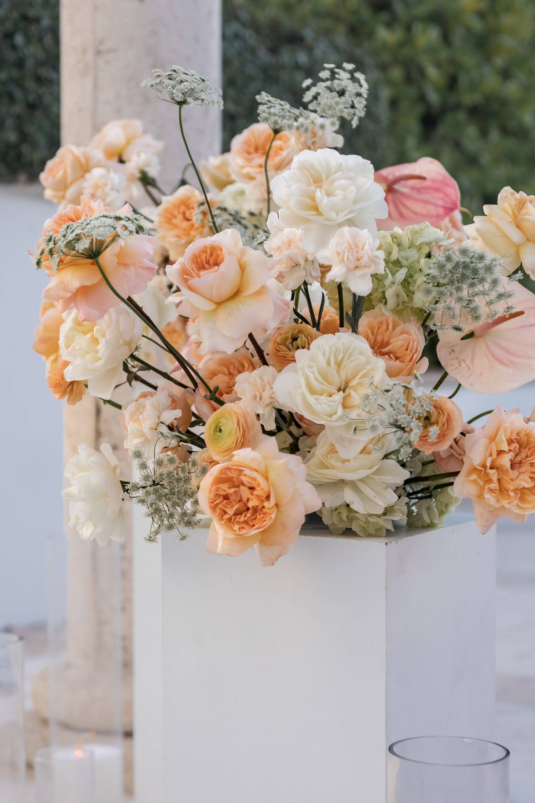 Peach flowers on white pedestals